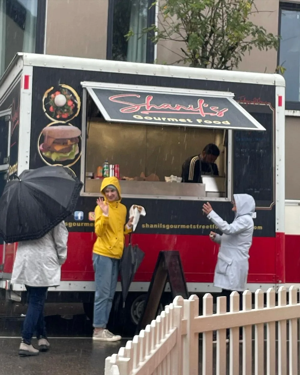 Customers standing at the Shanil's truck at an event
